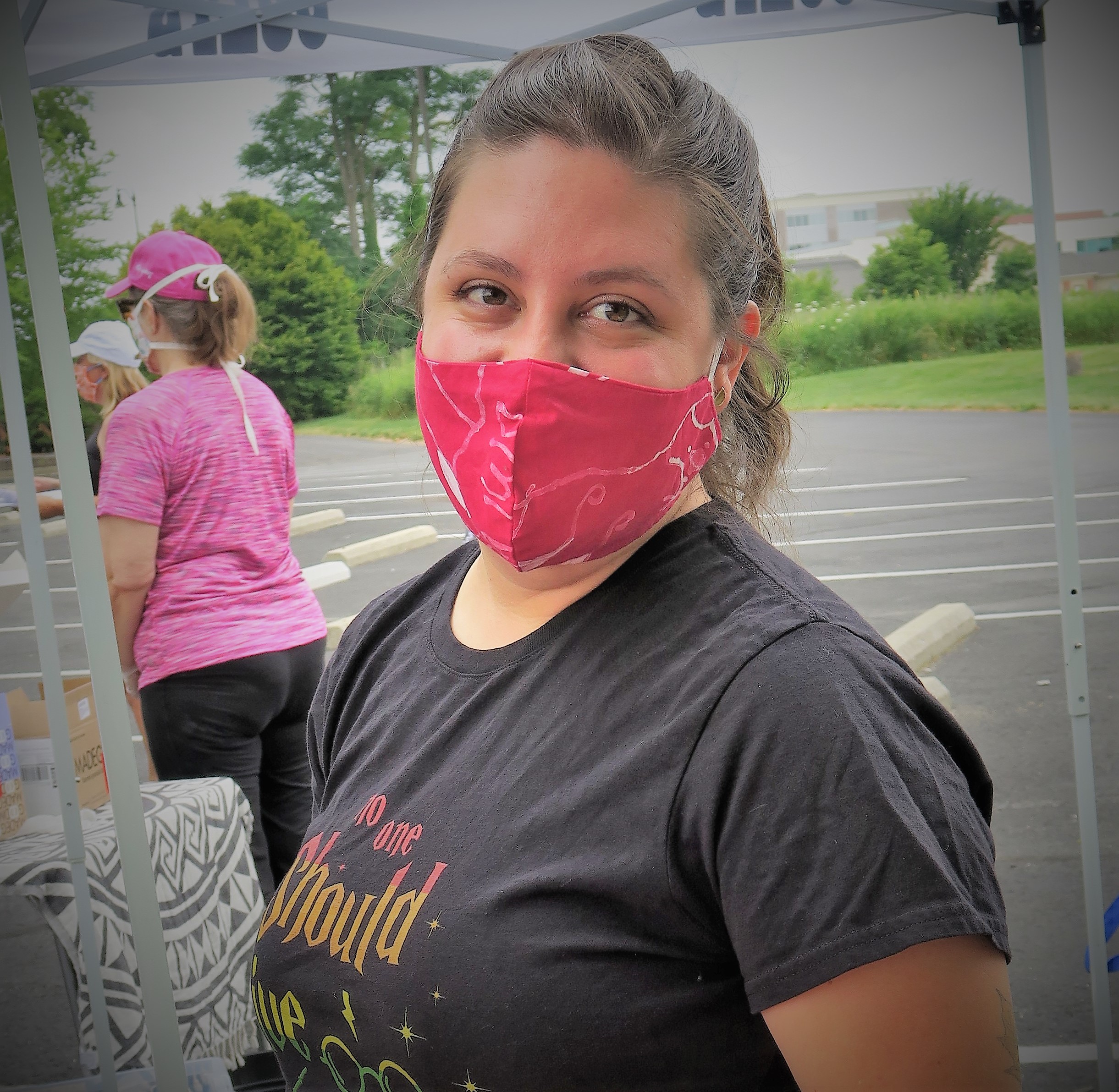 Becca,  wearing a mask, smiling