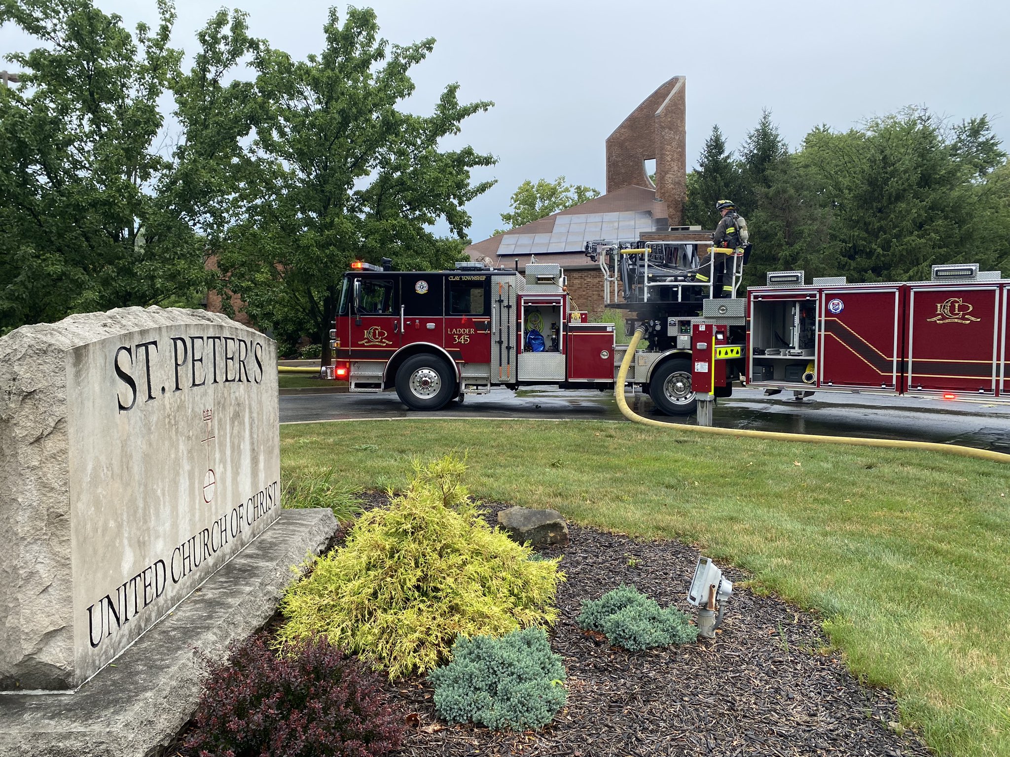 Fire truck in front of St. Peter's on July 28, 2023 Red fire truck in front of a brick church building